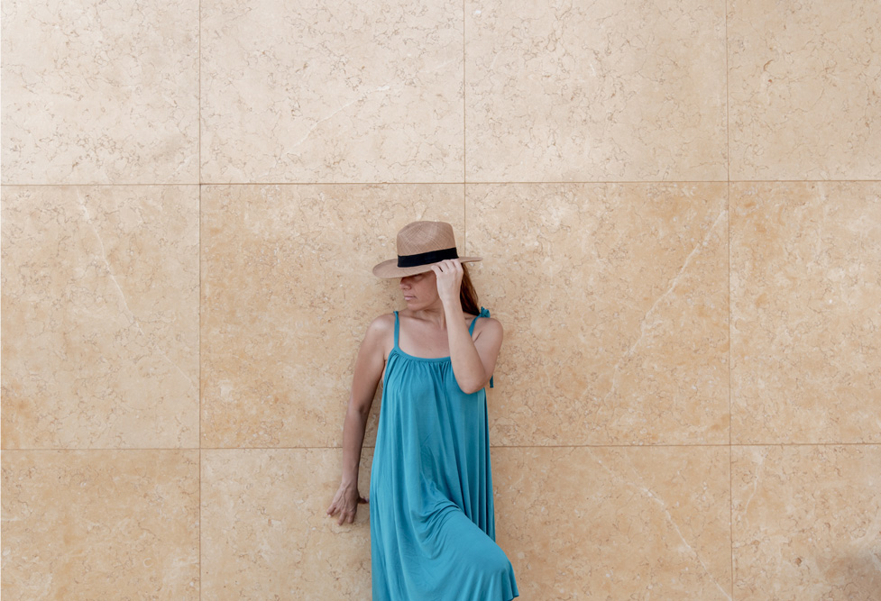 Woman posing in a hat outside Cretan Dream Resort